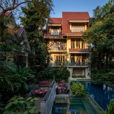 Best hotels in Bangkok | Sunlight falling on gorgeous four-storey hotel Ariyasom Villa and its pool, surrounded by trees