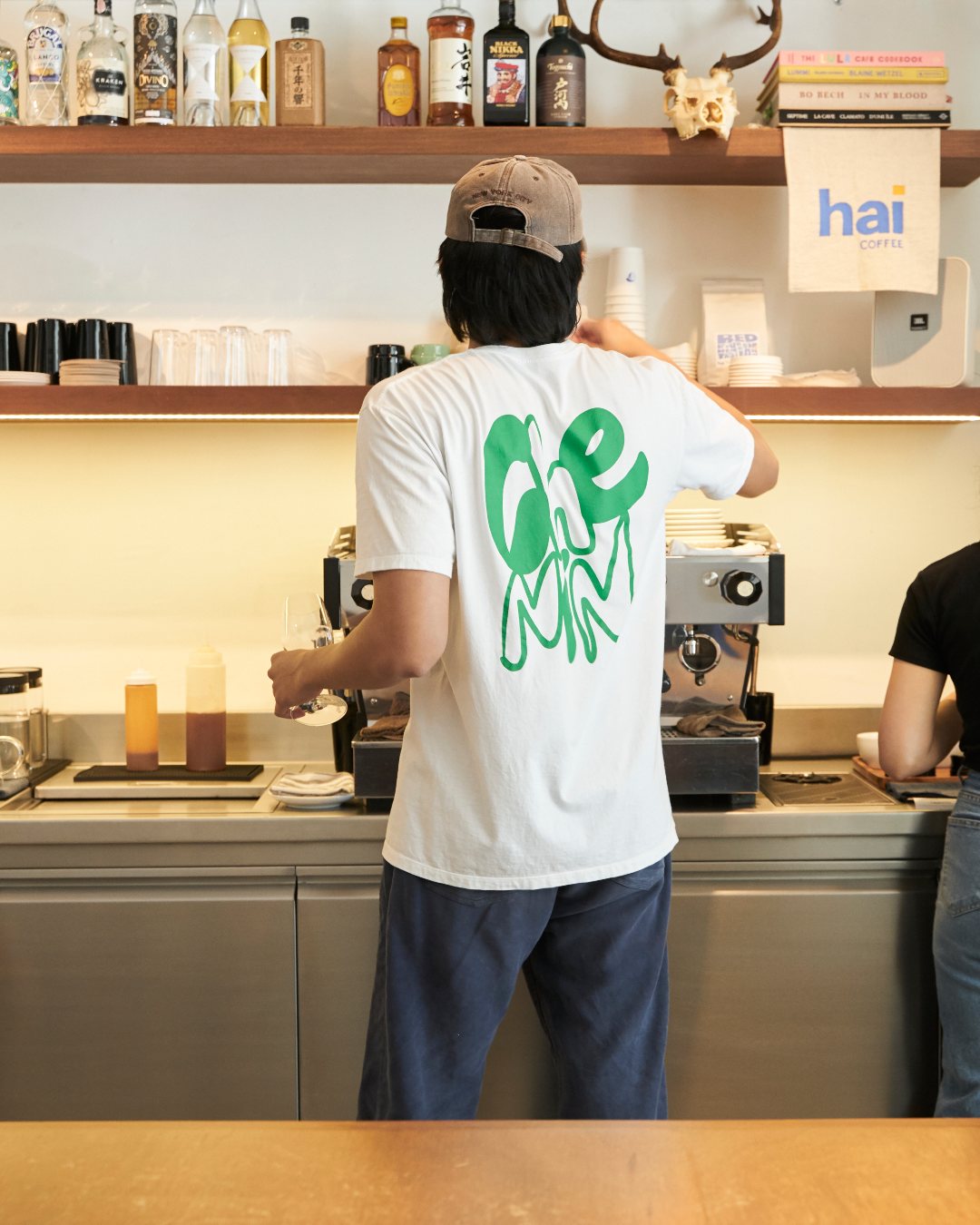 A staff member wearing a graphic t-shirt at Chenin in Bangkok