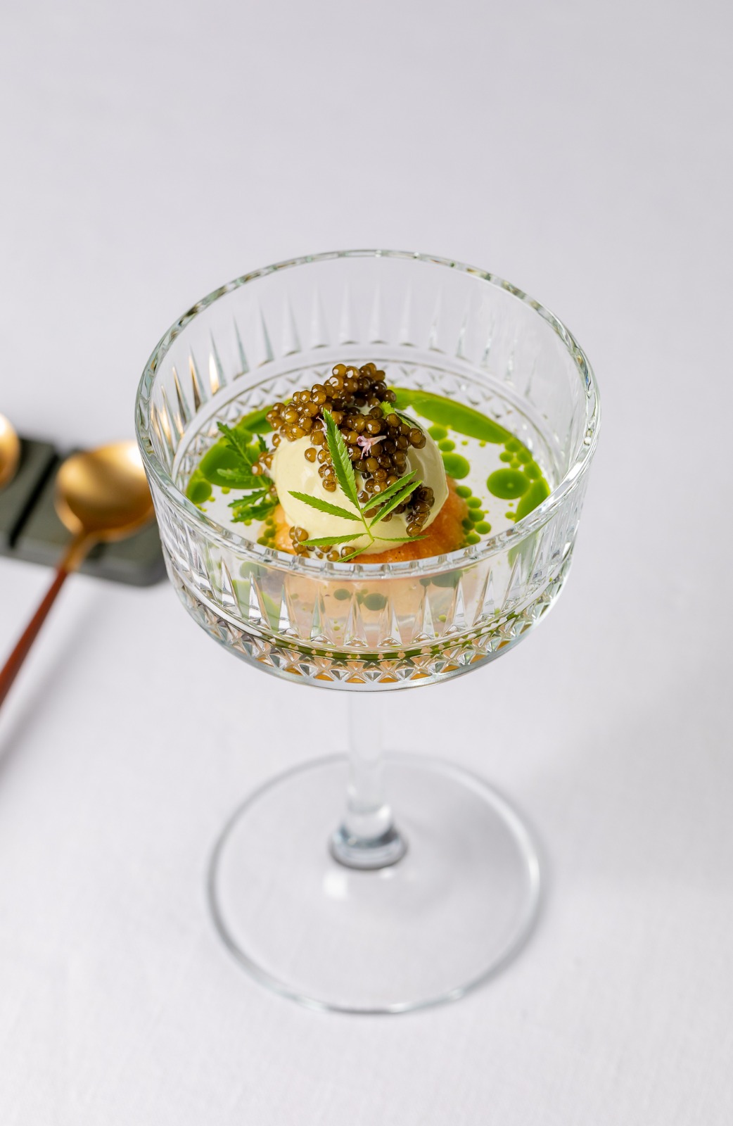 Best London restaurants | a delicate dish with drops of green oil is served inside an art deco style coupe glass at Da Terra