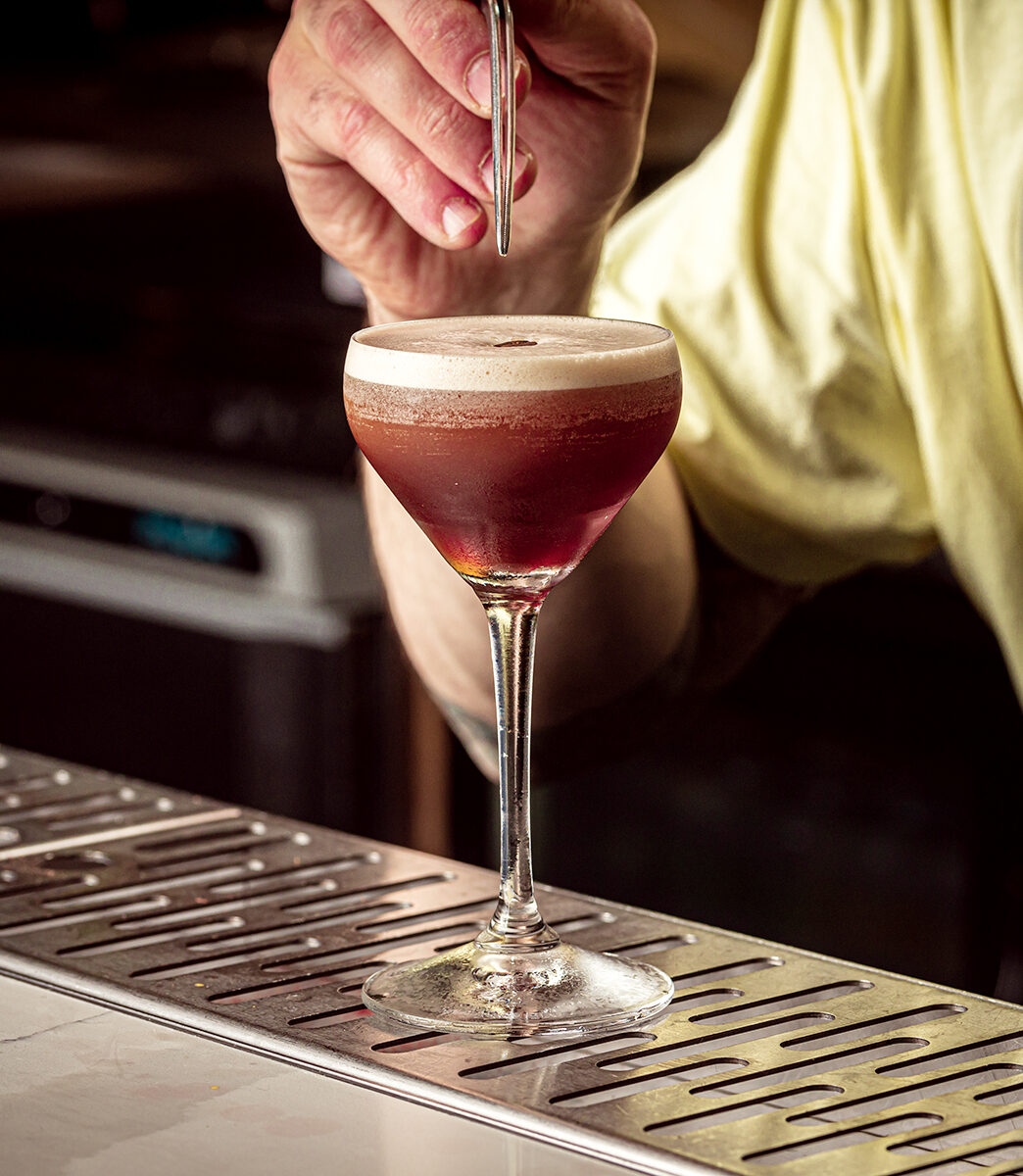 London's best cocktail bars | a bartender using a pipette to taste the espresso martini at Funkidory