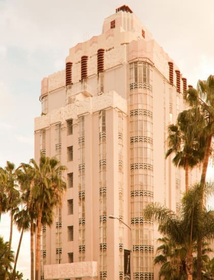 The best cocktail bars in LA | A shot of Sunset Tower Hotel on Sunset Boulevard, flanked by palm trees