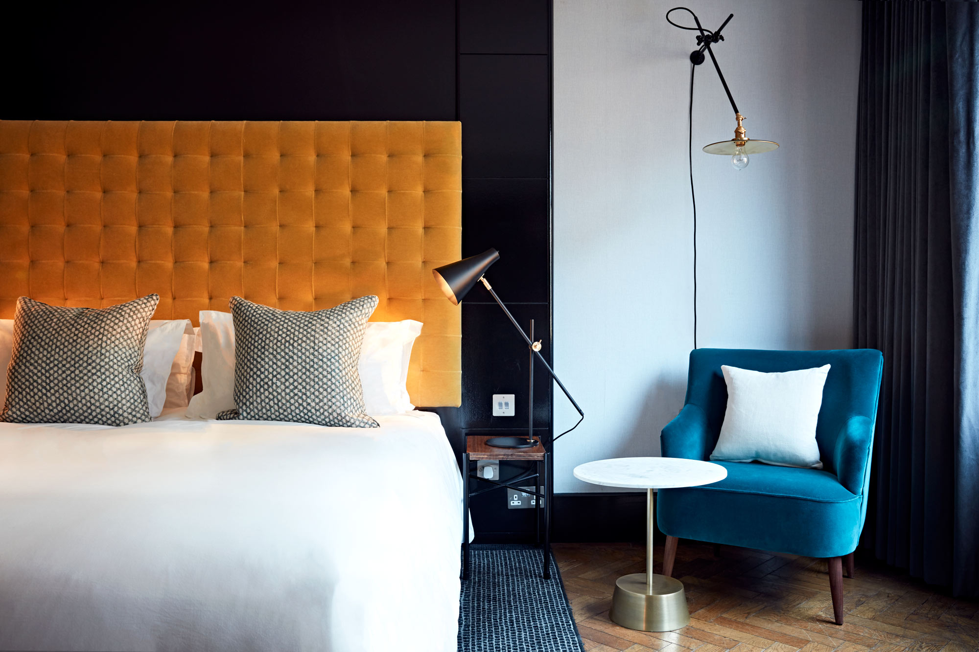 A room at The Hoxton in Shoreditch with a bed and chair in view