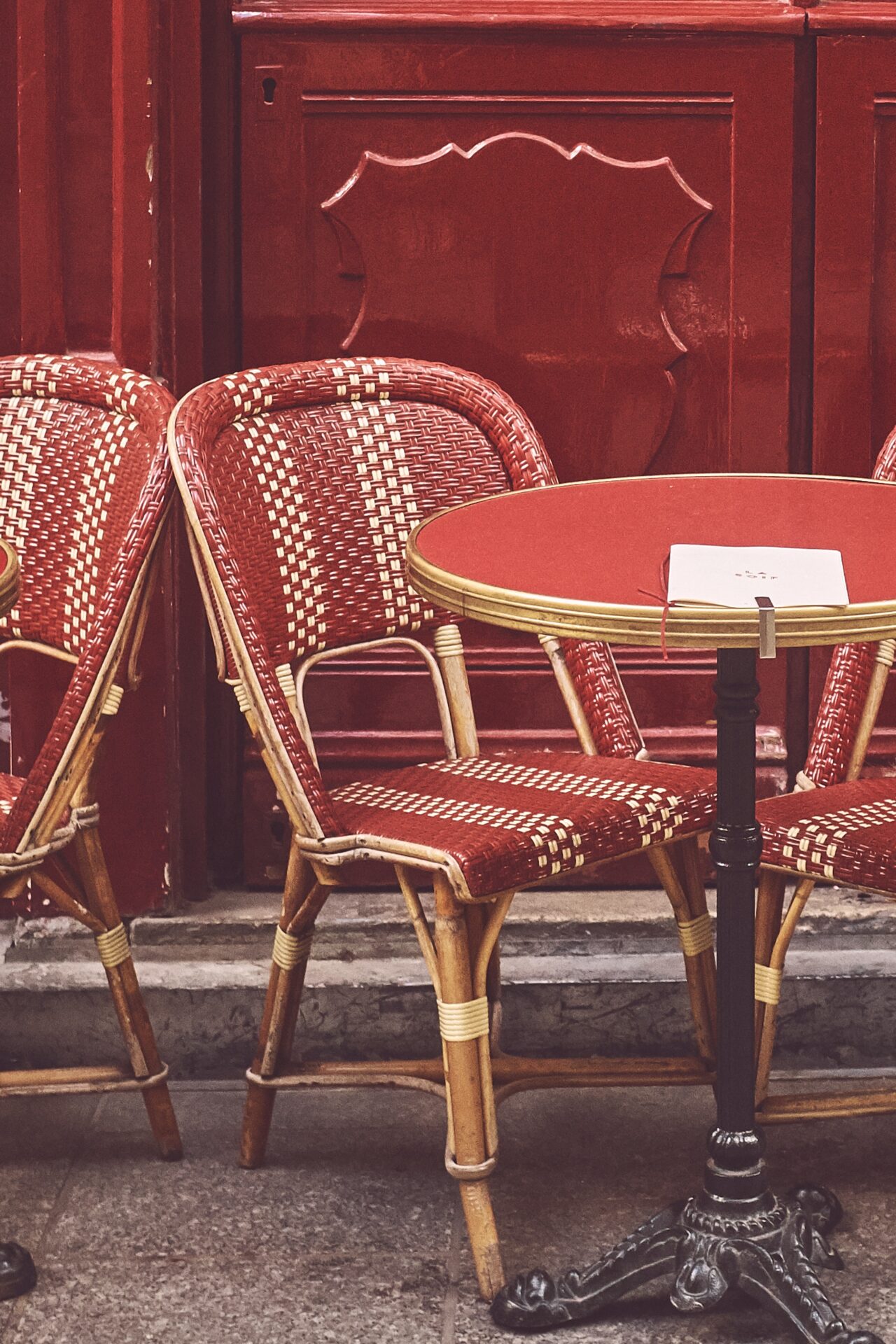 Is the hidden gem dead? A view of a red bistro chair by a red round table on a street