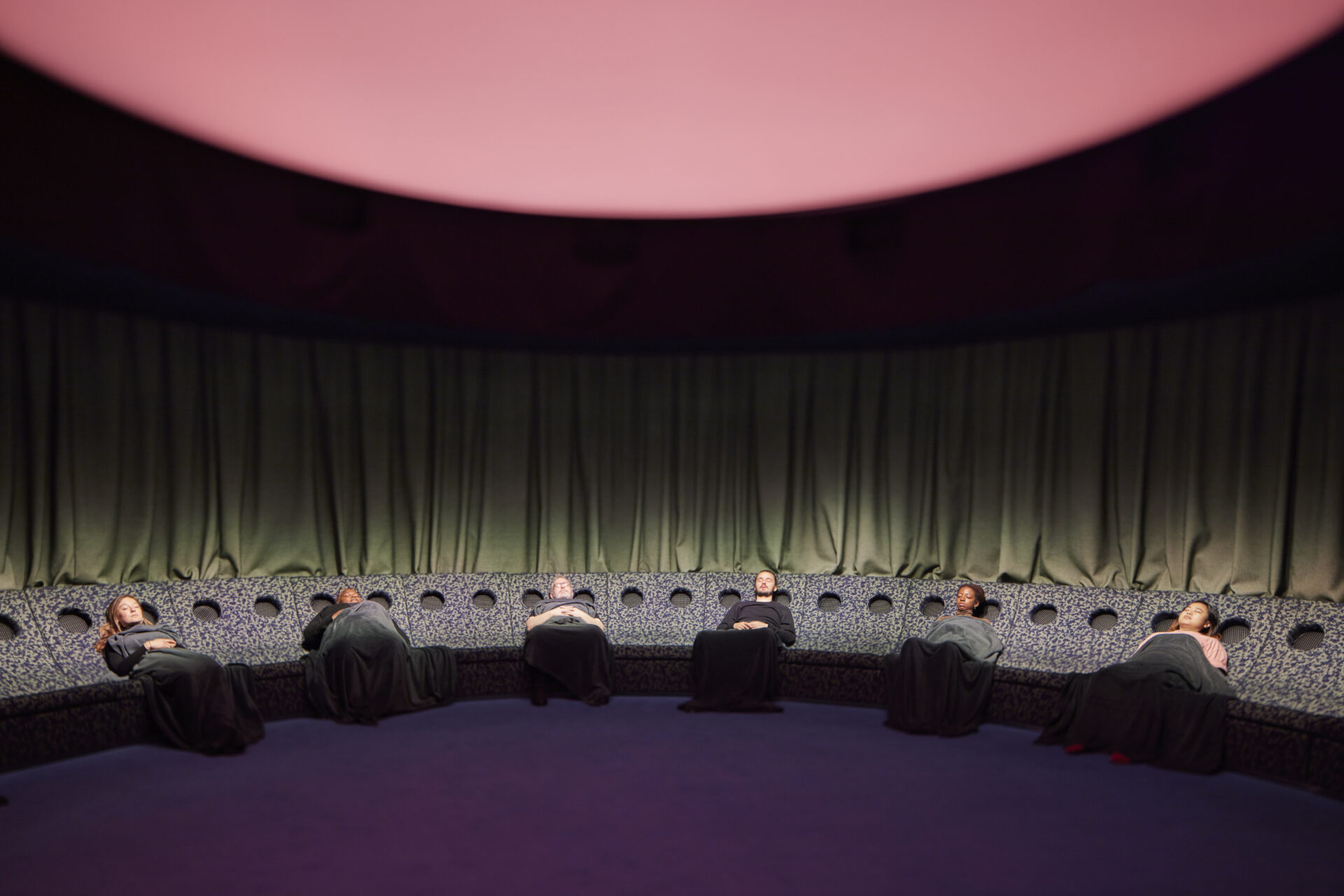Things to do in London in June | Five people lying back under blankets with their eyes closed experiencing Dreamachine