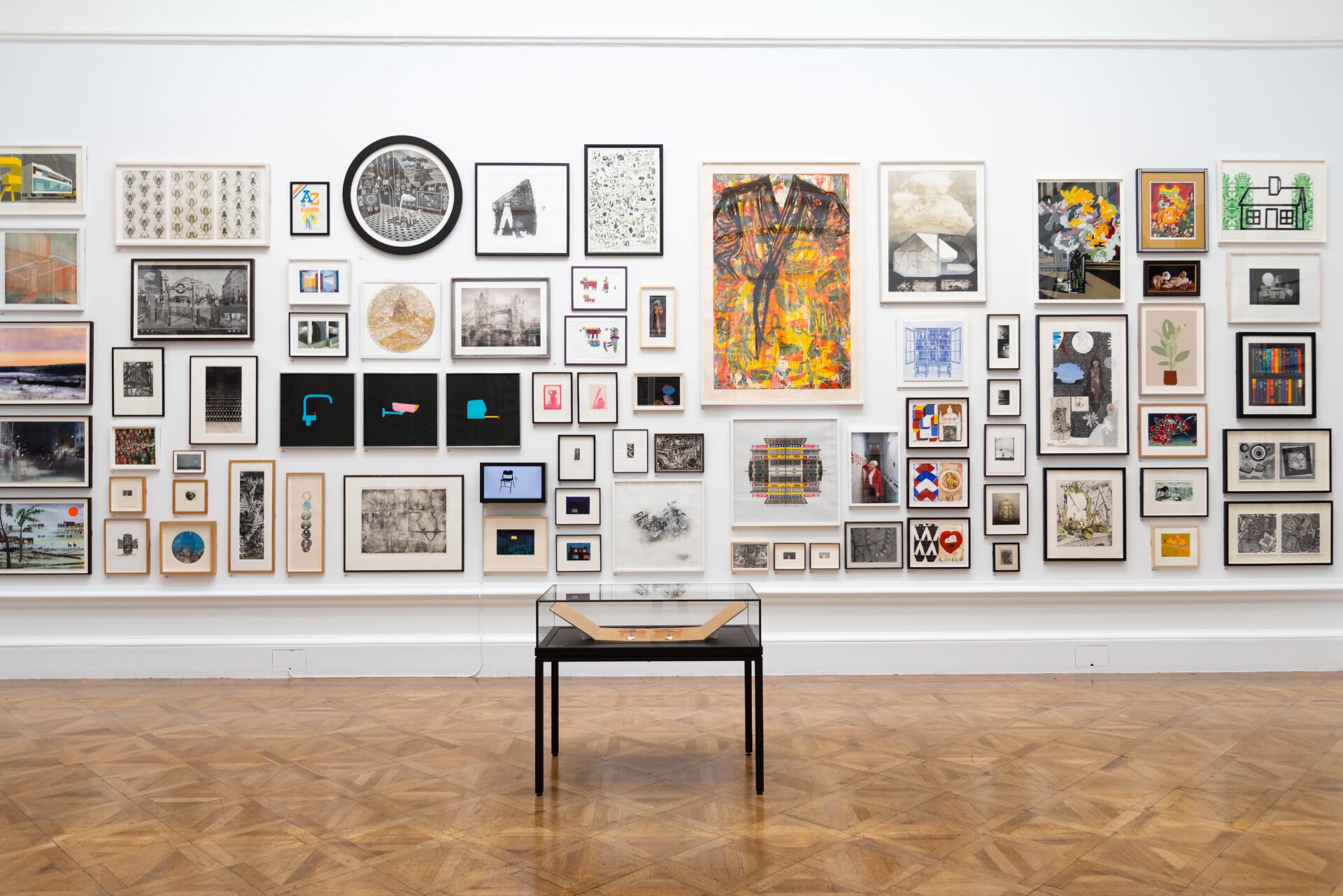 Things to do in London in June | A selection of pieces from the RA's Summer Exhibition hanging on a white all at the Royal Academy