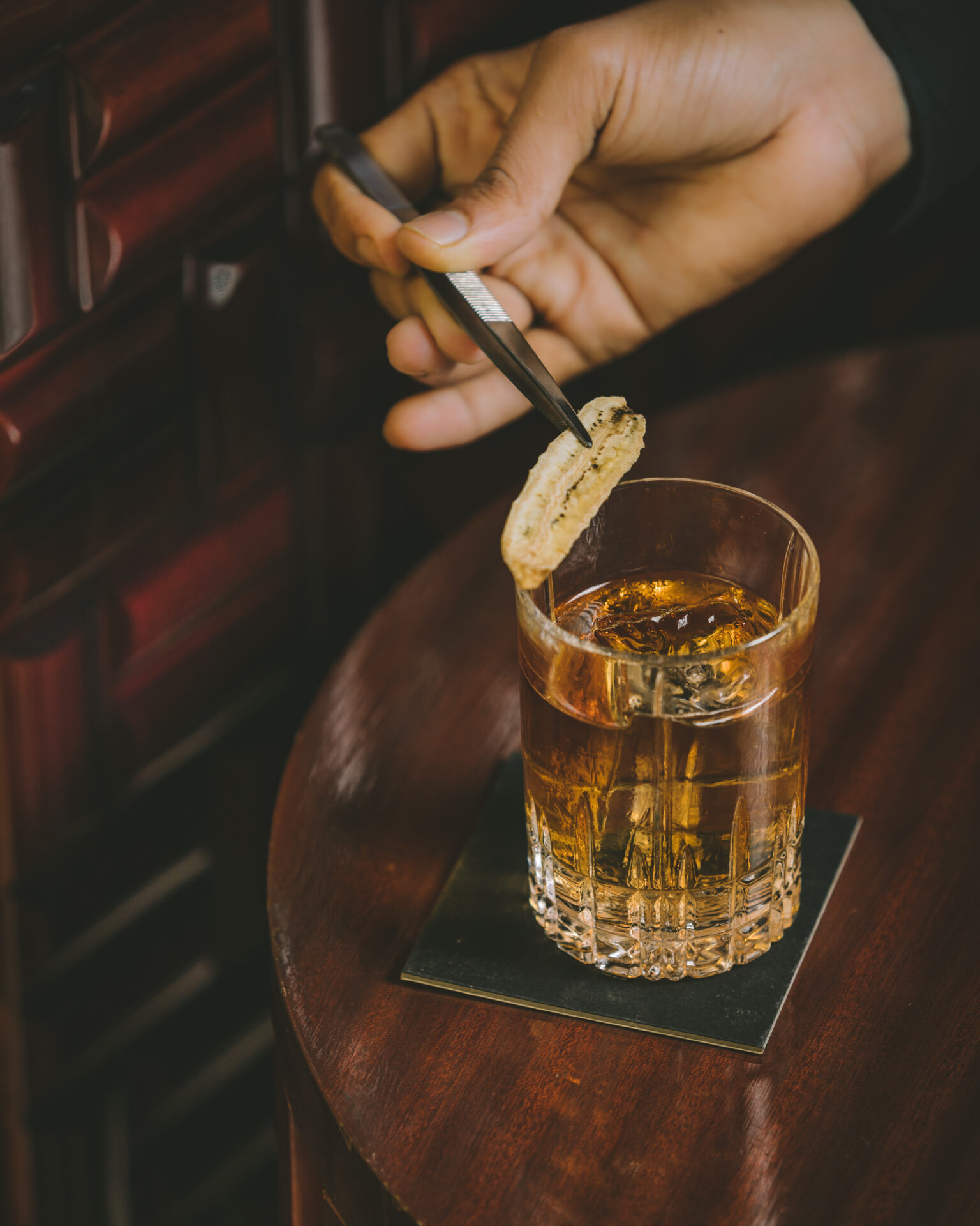 Best bars in Mumbai | Aer rooftop bar and lounge, a cocktail served on a wooden tabletop