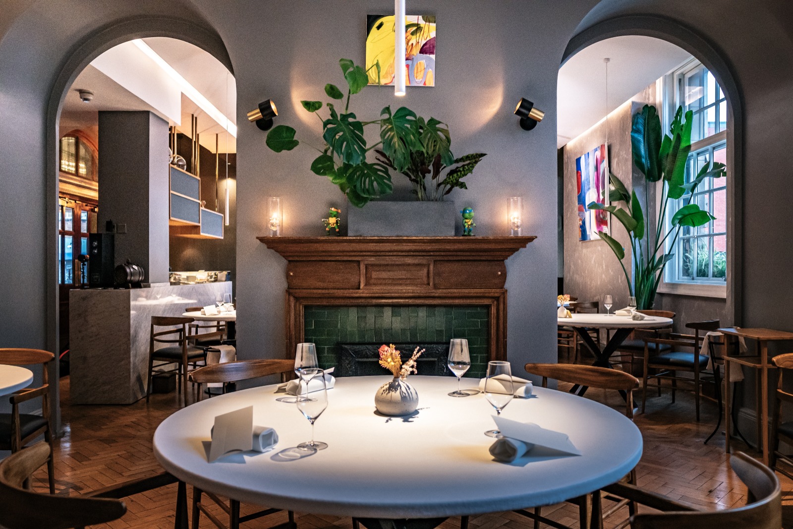 Best London restaurants | The dining room at Da Terra, with a round table laid out with glassware and napkins, midcentury modern wooden chairs and parquet flooring