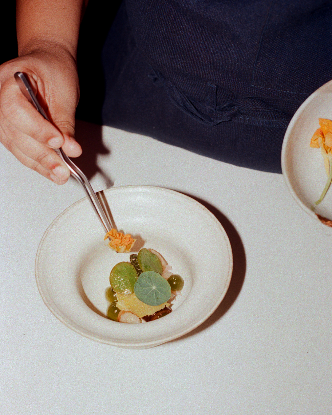 Chef plating up a dish at Ekaa Mumbai