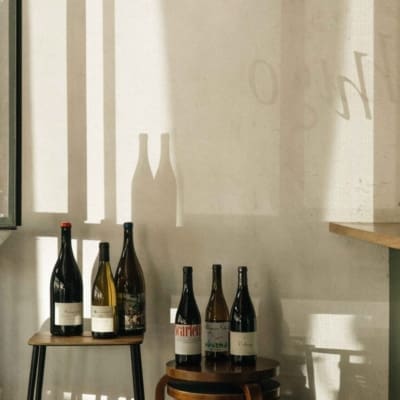 The best bars in Mexico City | A view of wine bottles on stools at Hugo El Wine Bar