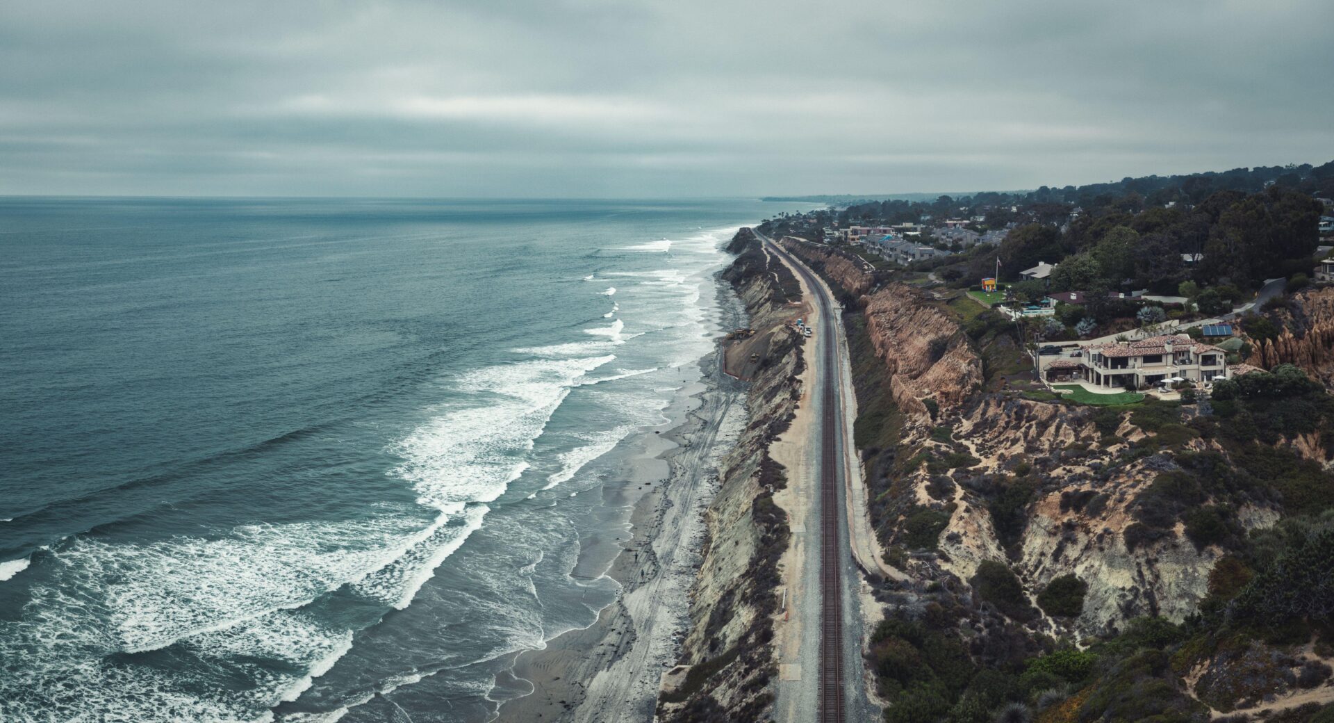 LA to San Francisco by Amtrak | The train tracks hugging the rugged California coastline in Del Mar, travelling along stormy seas