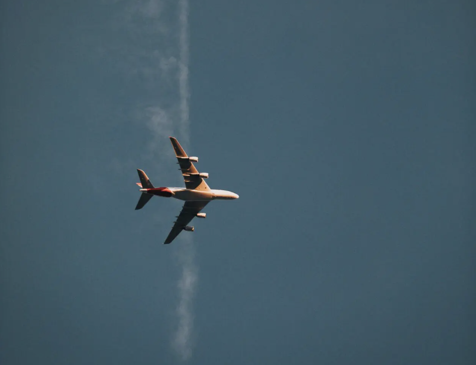 Airline news | a plane flying in the sky, photographed from below