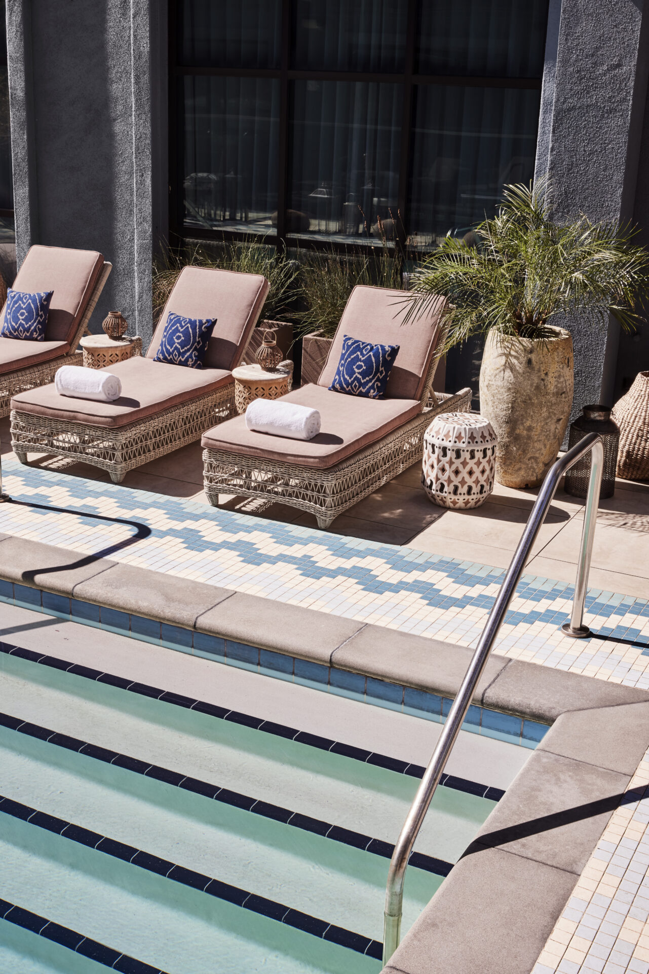 The pool at The Aster, Hollywood Los Angeles | sunbeds with pink cushions overlooking the turquoise pool