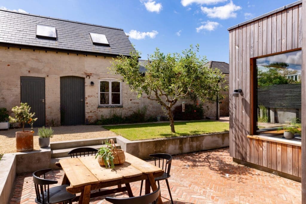 Exterior of The Space at Caro, Bruton | a farmhouse below a blue sky