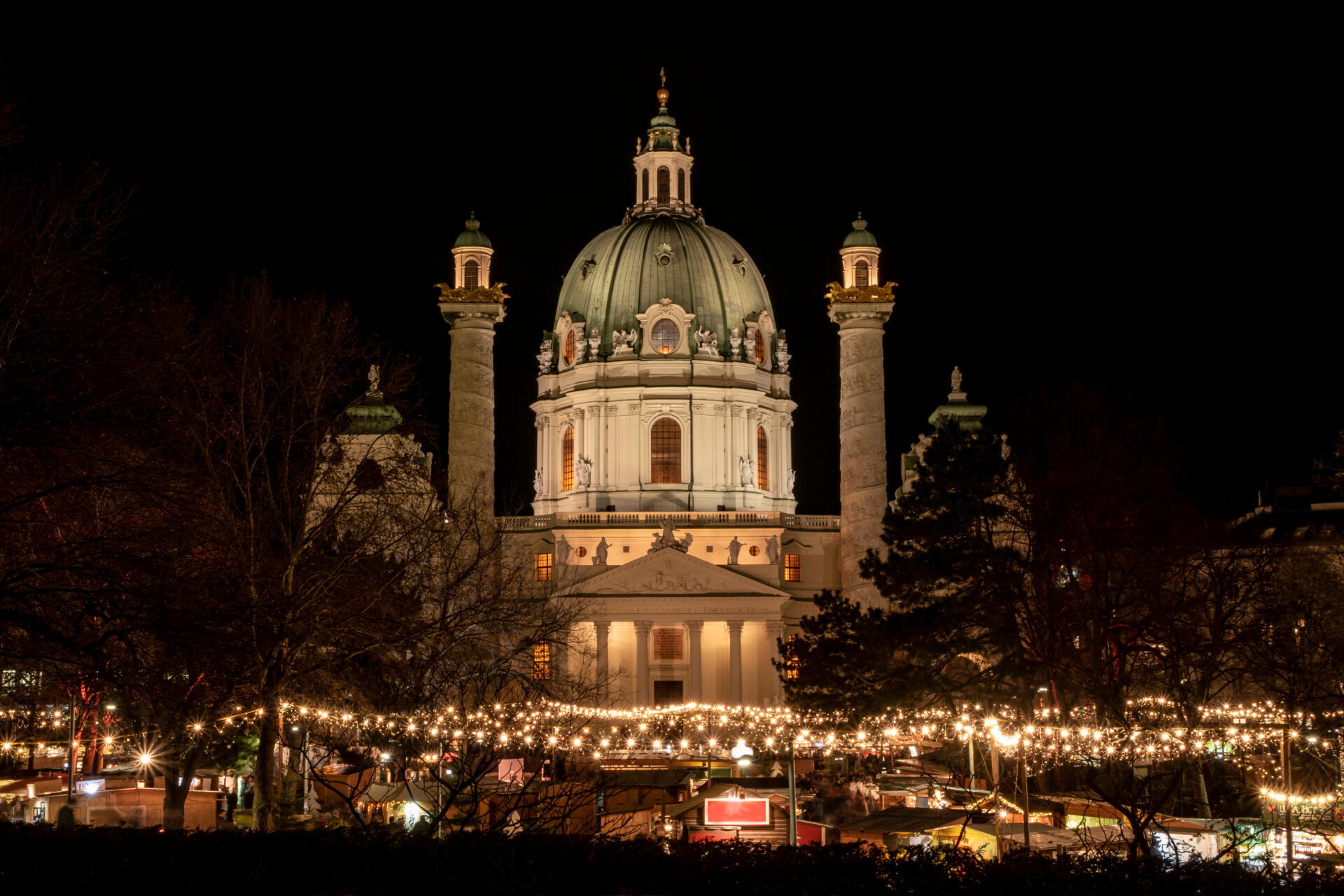 A historic domed building lit up at night in Vienna, Austria