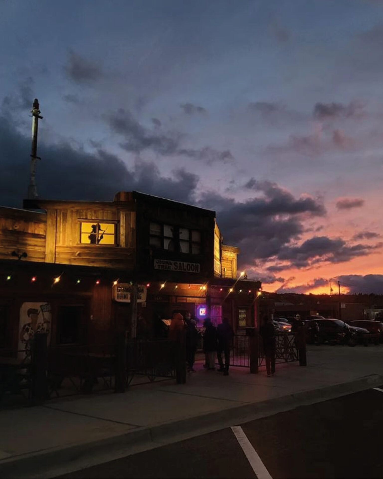 The best things to do in Joshua Tree | JT Saloon lit up beneath the desert night sky