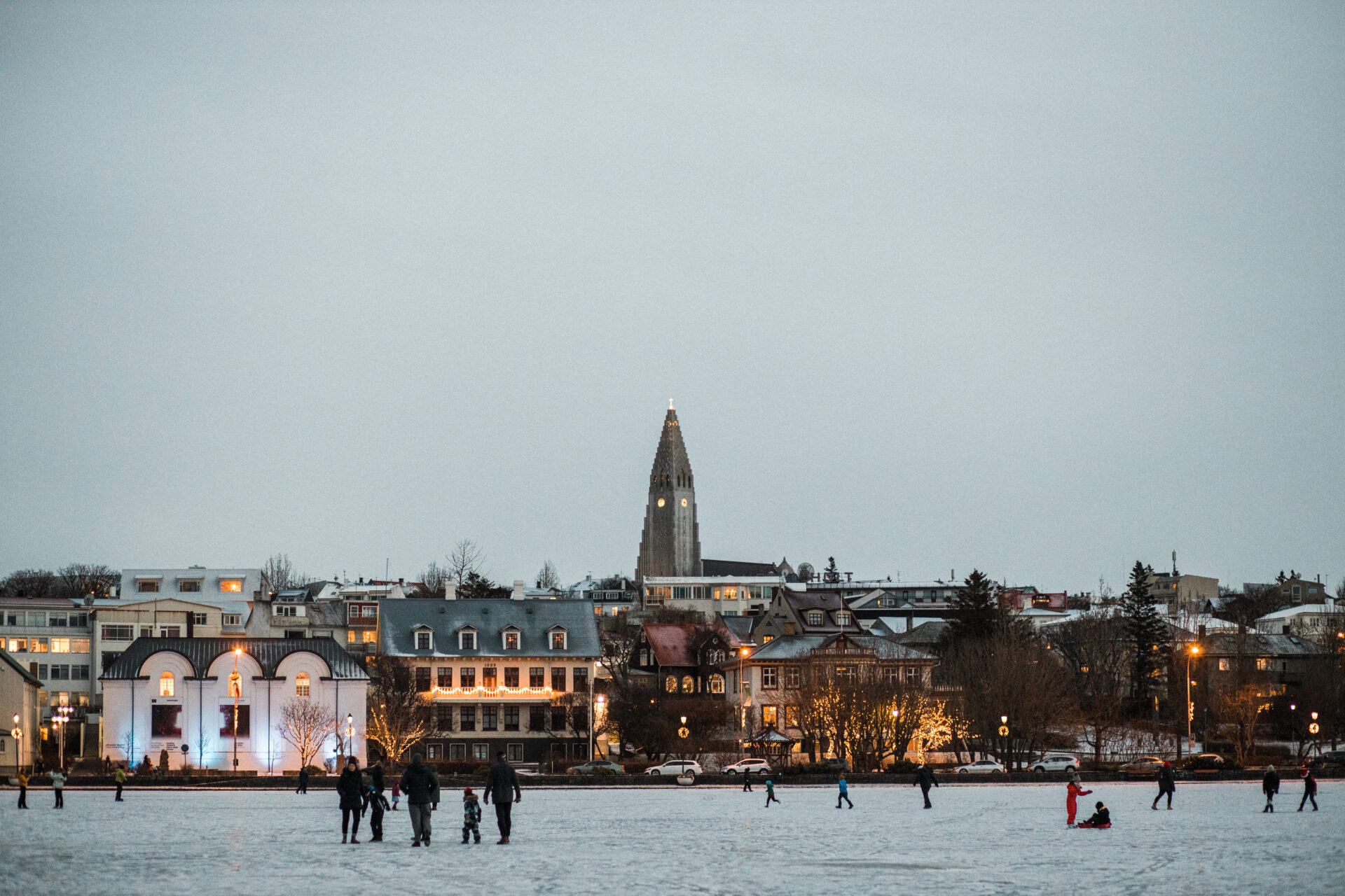 Crowds walk across the snow in Reykjavik, Iceland