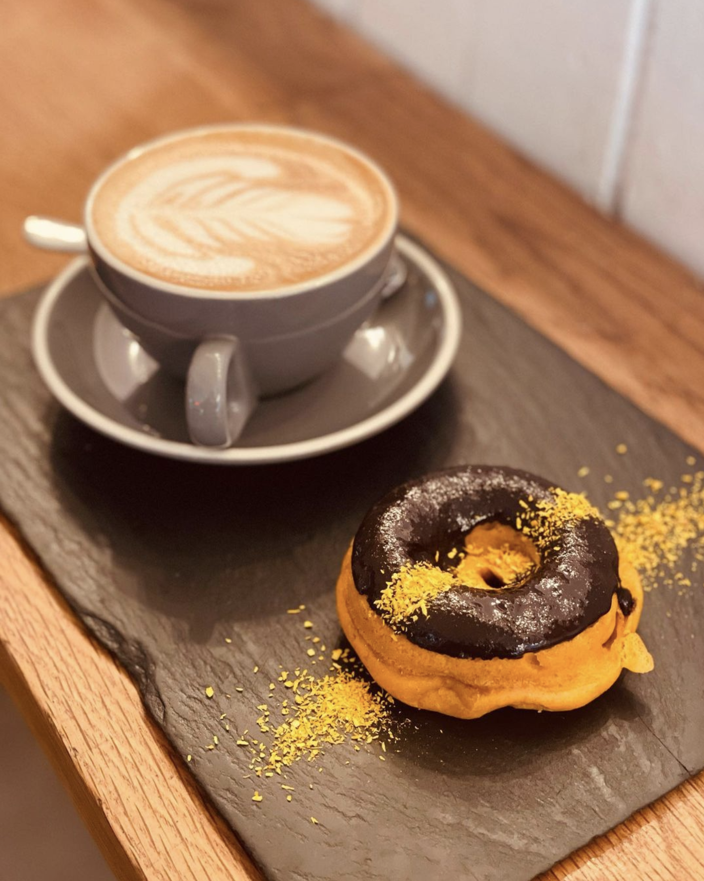 A cup of coffee and a pumpkin doughnut at Scheckter’s Raw, Sea Point