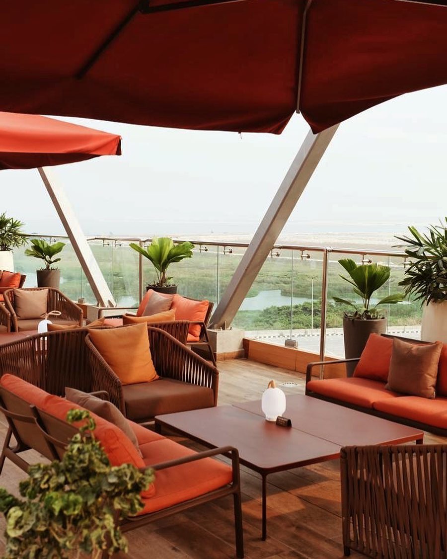 Nigerian author Damilare Kuku on how to make the most of Lagos | Túraká Restaurant on the roof of EbonyLife Place with orange cushioned chairs