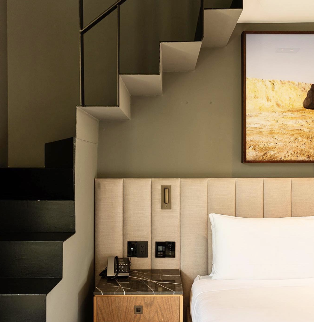 The best hotels in Roma Norte, Mexico City | crisp white bed linen with a stair to the left