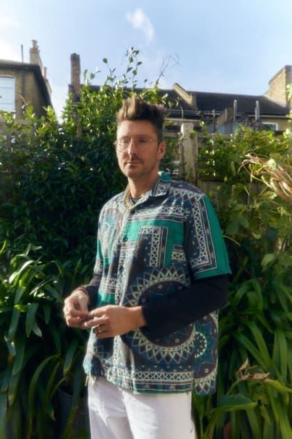 In the studio with Henry Holland | Henry Holland standing in the garden at the front of his studio.