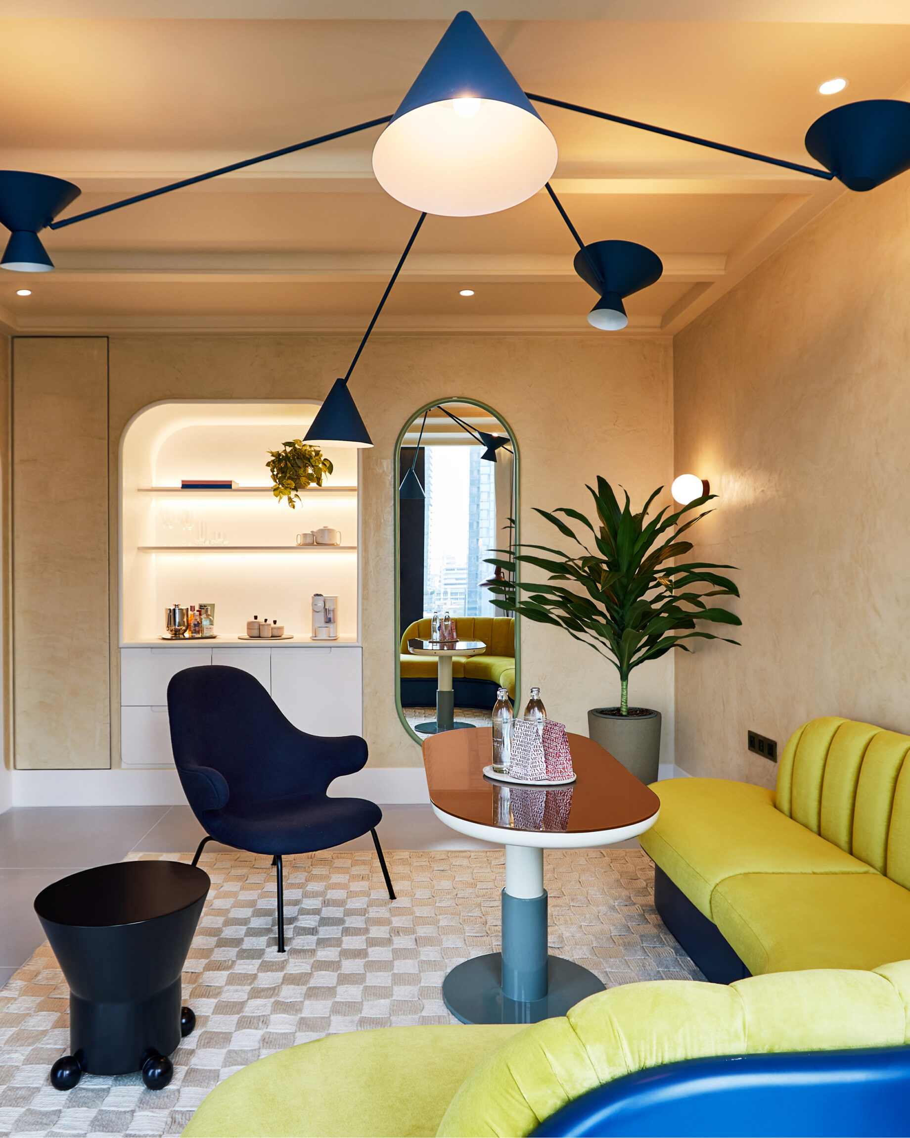 Room at the Standard Bangkok with a yellow couch and patterned rug