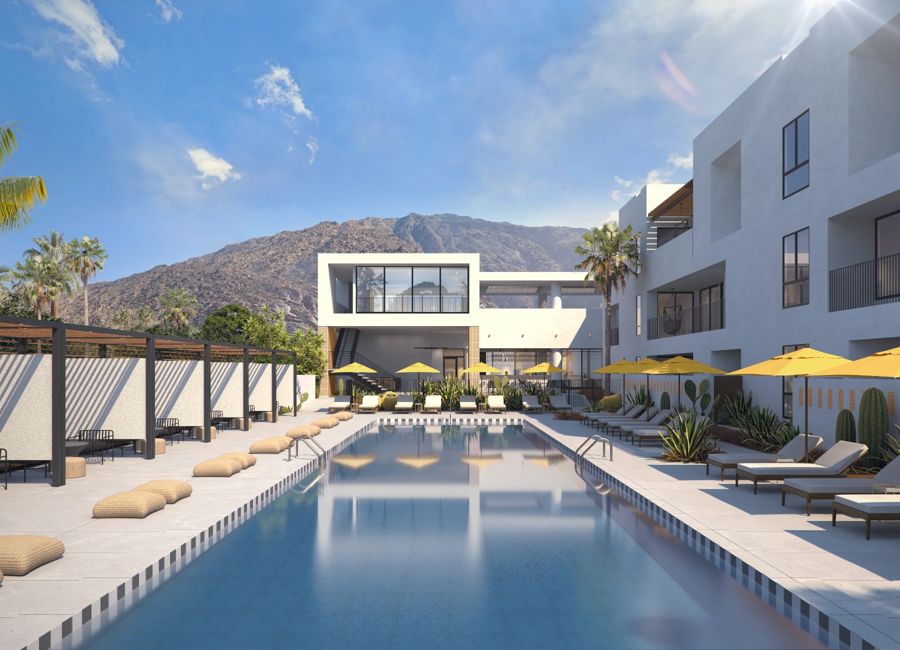 View of the inviting pool at Drift Palm Springs, surrounded by lush greenery and comfortable lounge chairs.