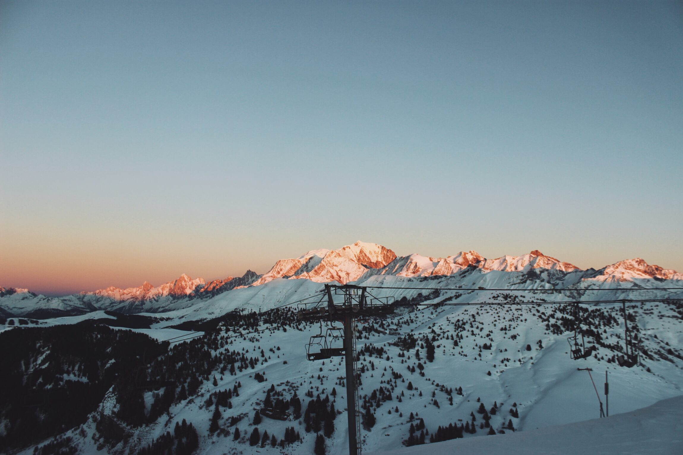 The most spectacular places to stay in the Alps this winter | Snow-capped peaks catching the last rays of the sun in Megeve