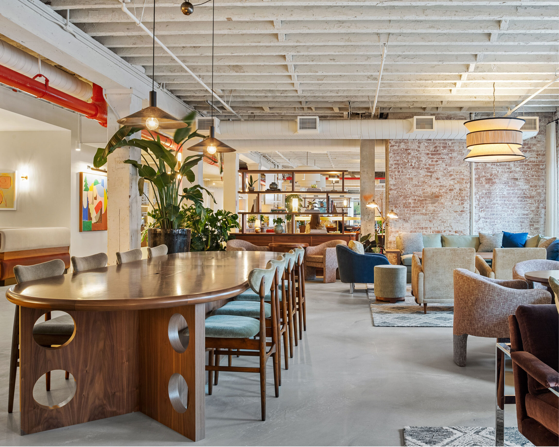 The best co-working space in New York | Open space at Soho Works with colourful chairs and paintings.