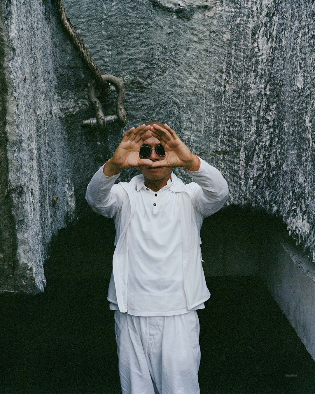 Chinese artist Zhang Huan standing in his Shanghai garden