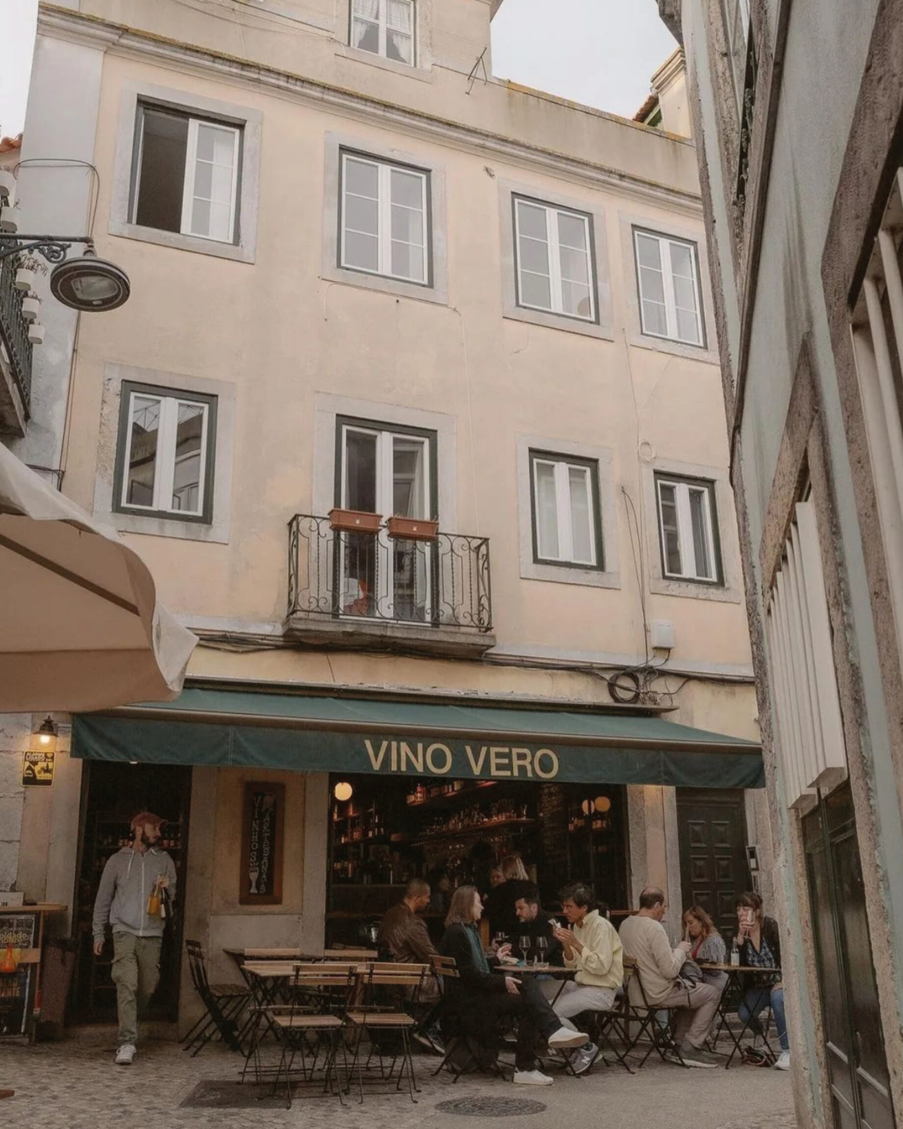 The green awning and outdoor seating at Vino Vero