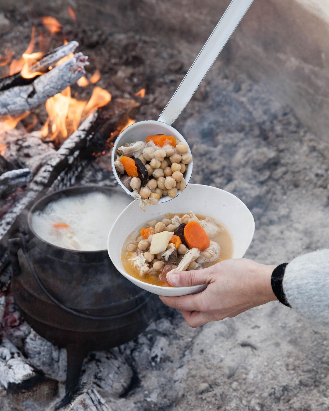 a dish of vegetables cooked on an open fire