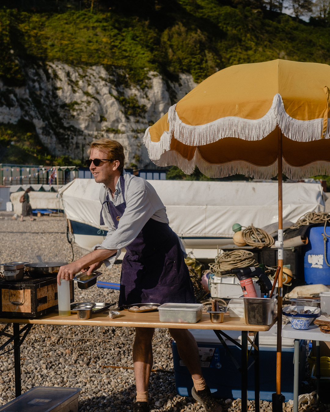 Preparing dinner on a beach near Glebe House in Devon.