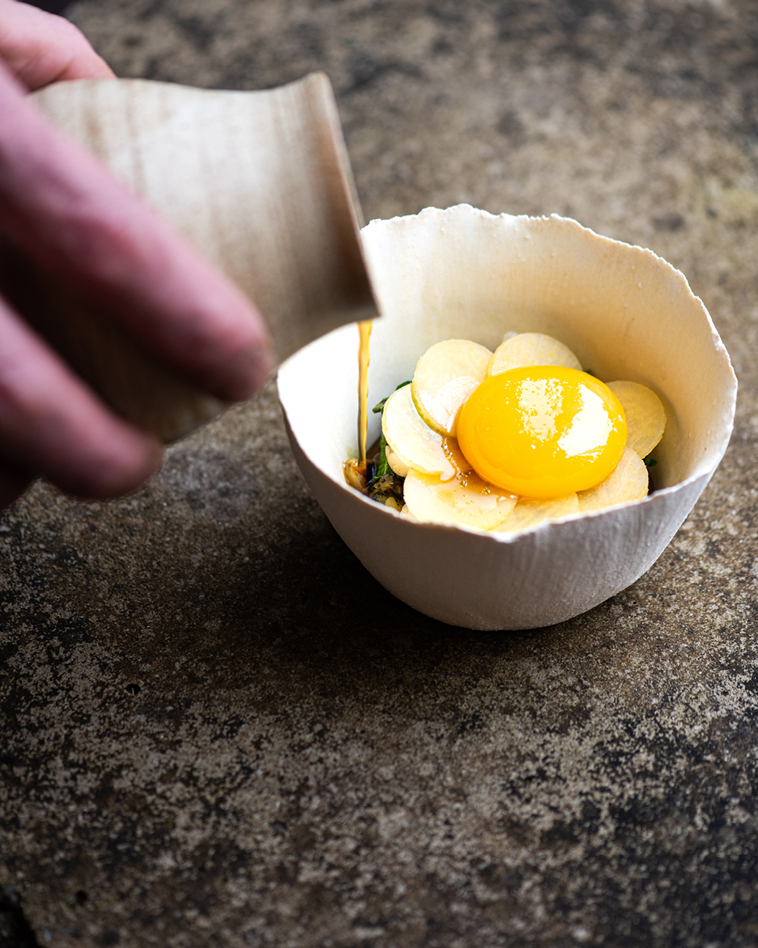 Beans, turnip and confit egg yolk served as a dish at Crocadon Farm restaurant.