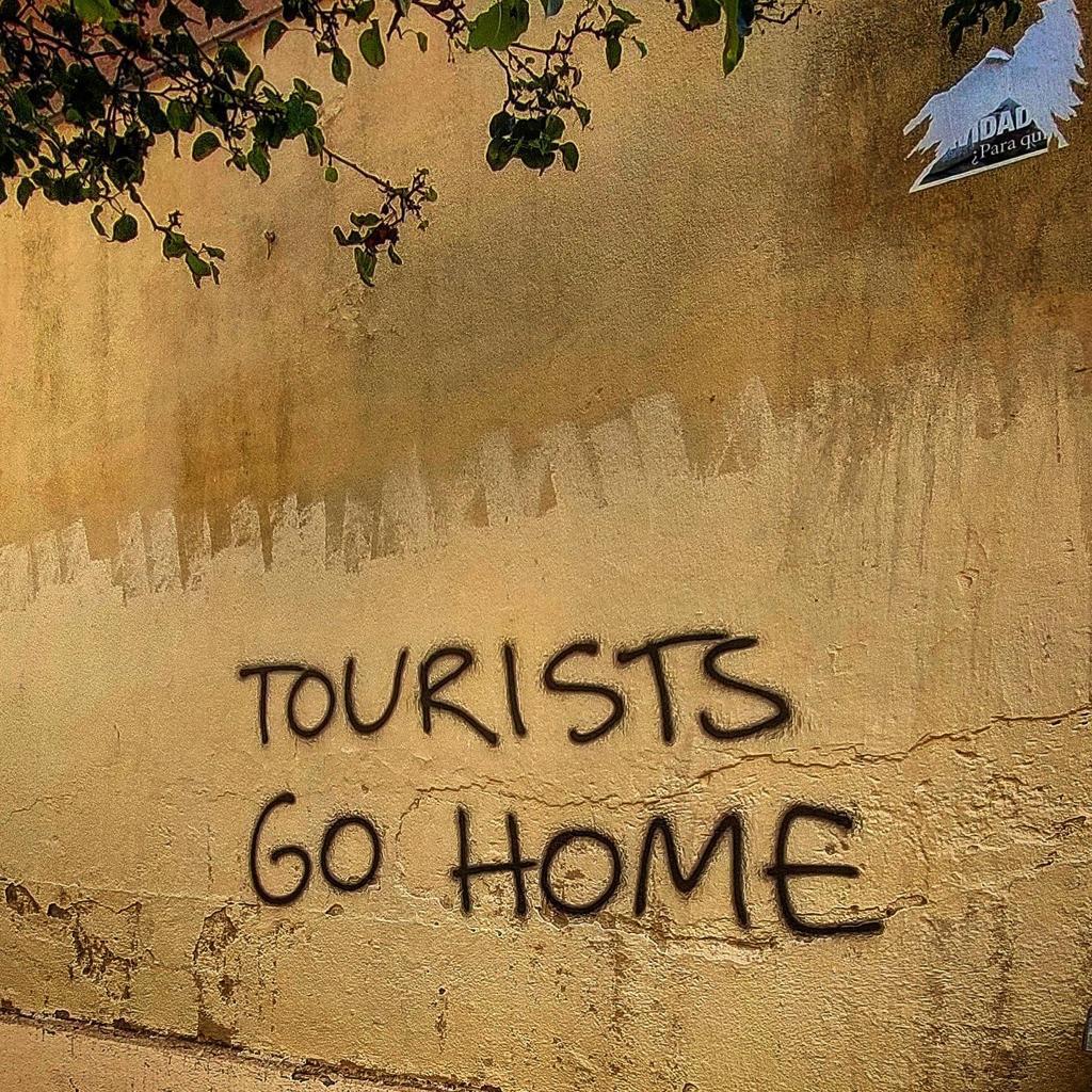 Graffiti on a wall in Barcelona urging tourists to 'Go Home' 