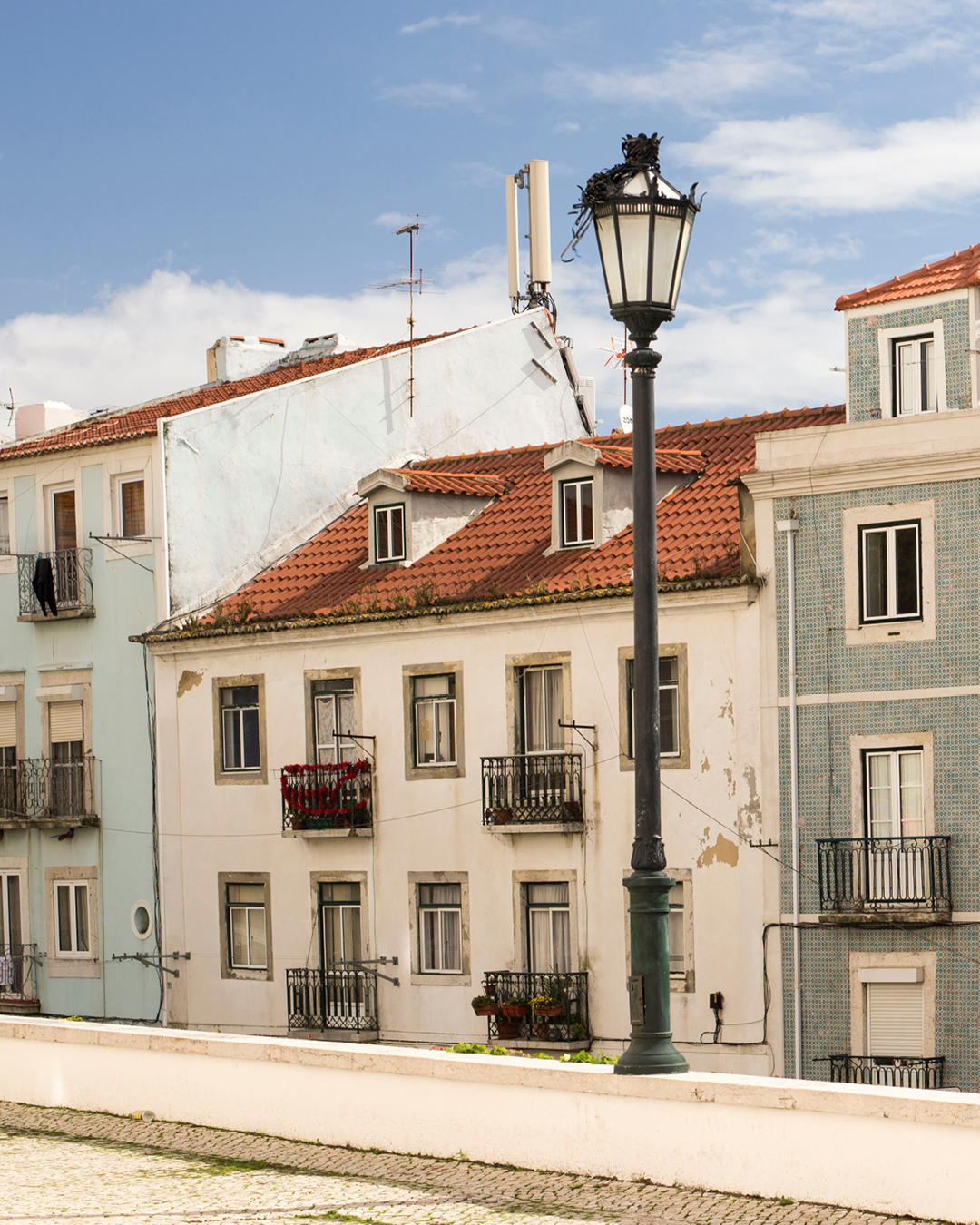 Crumbling plaster on pastel building in Lisbon