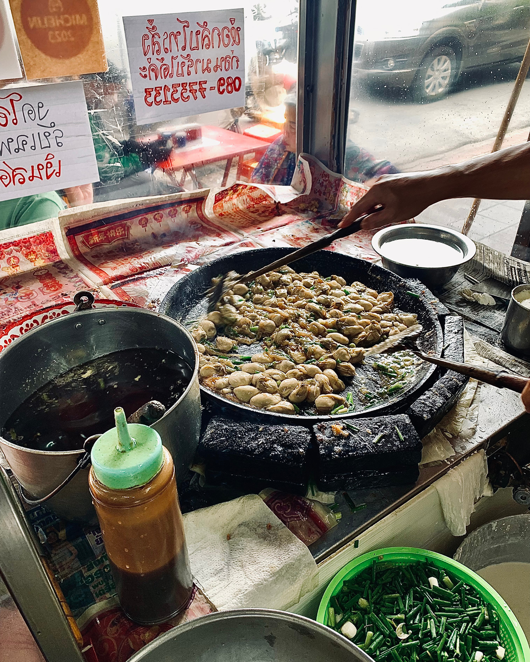 a woman cooking at Nai Mong Hoi Tod