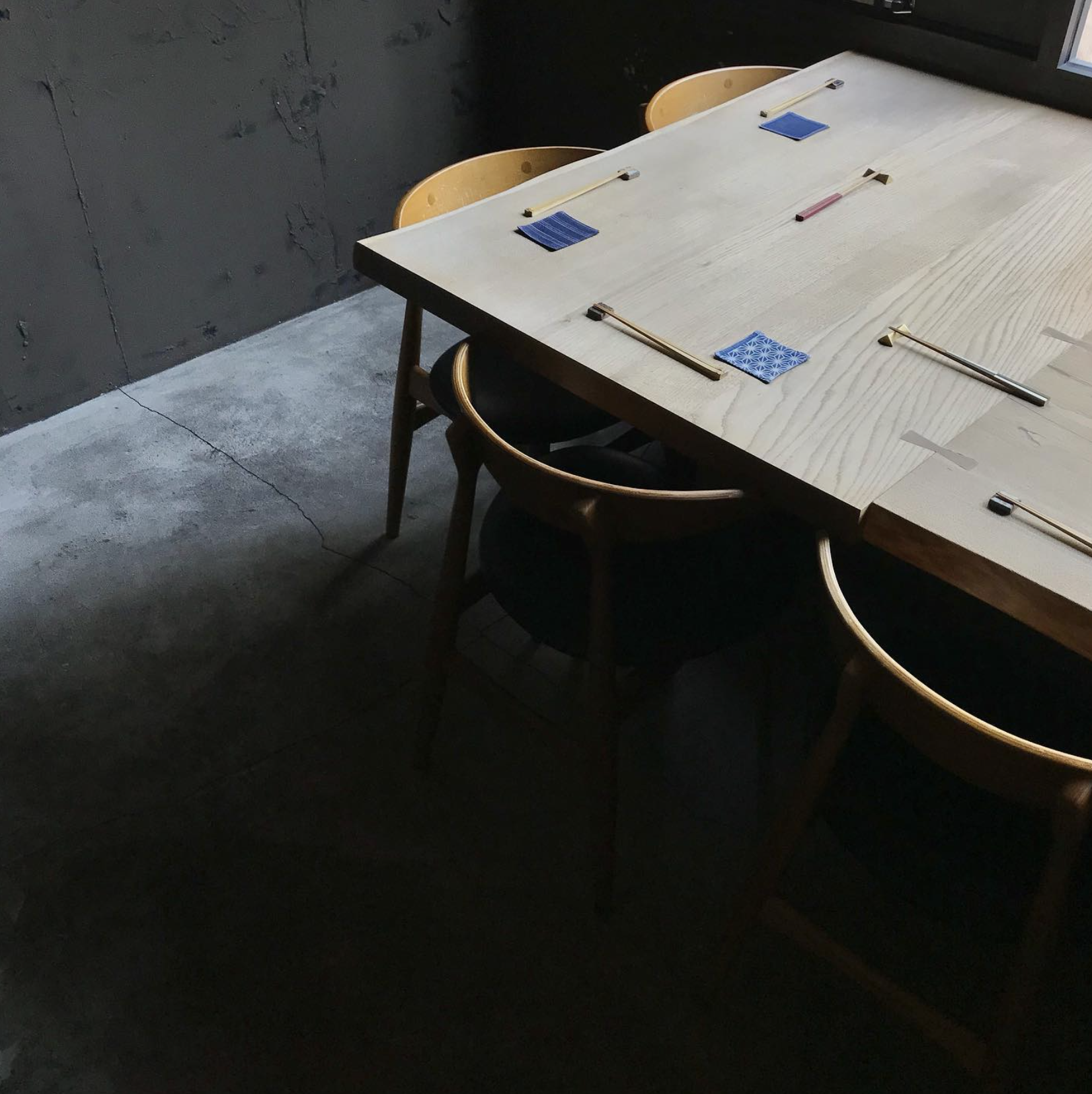 A wooden table set with chopsticks at Sowado, a sophisticated izakaya in Tokyo