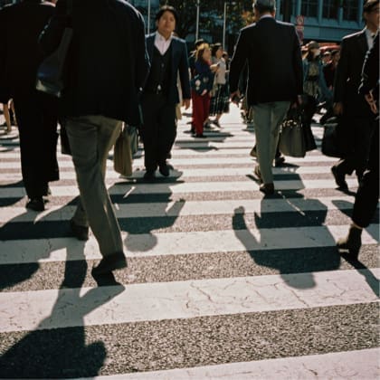 Shadows of people seen crossing the Sibuya Crossing