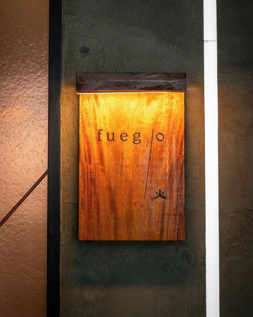 The best restaurants and bars in Bangkok's Thonglor | A wooden sign for the restaurant Fuego in Bangkok.