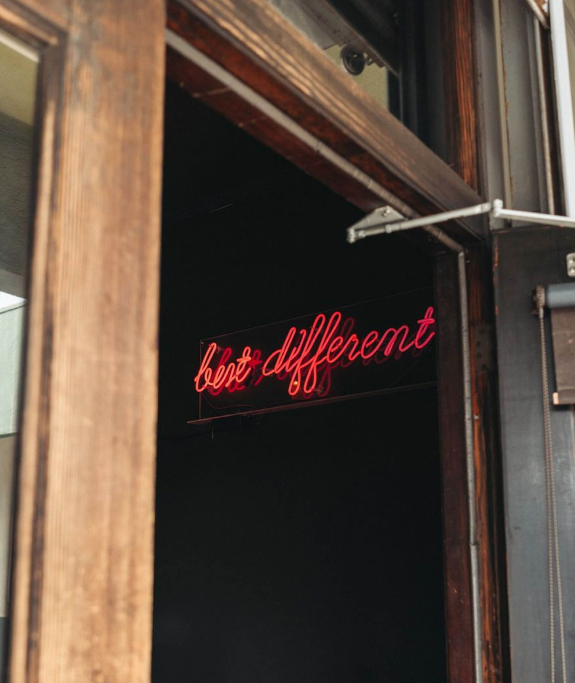 The doorway of Same Same in Silver Lake, Los Angeles, with a neon sign