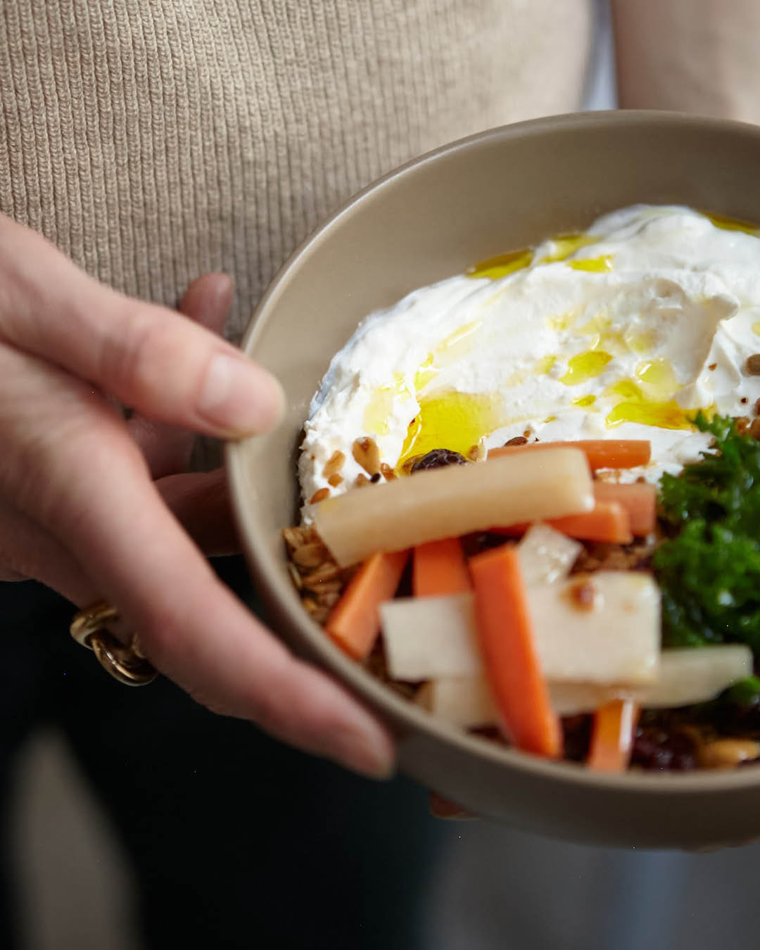 A healthy salad bowl served at Café Méricourt in Paris, held by a waiter.