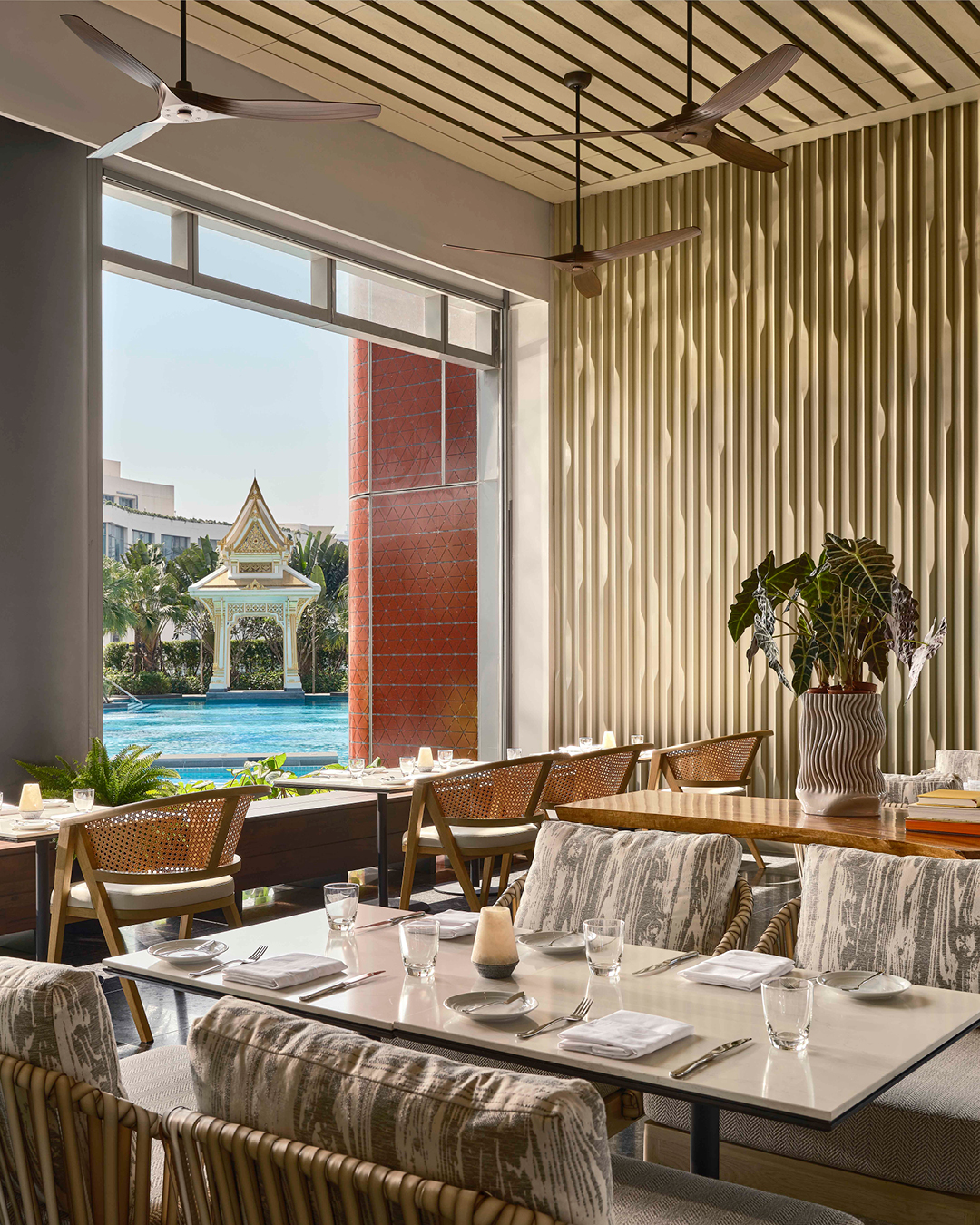 Set tables looking out to pool and sala at Flow restaurant at Chatrium Grand Bangkok