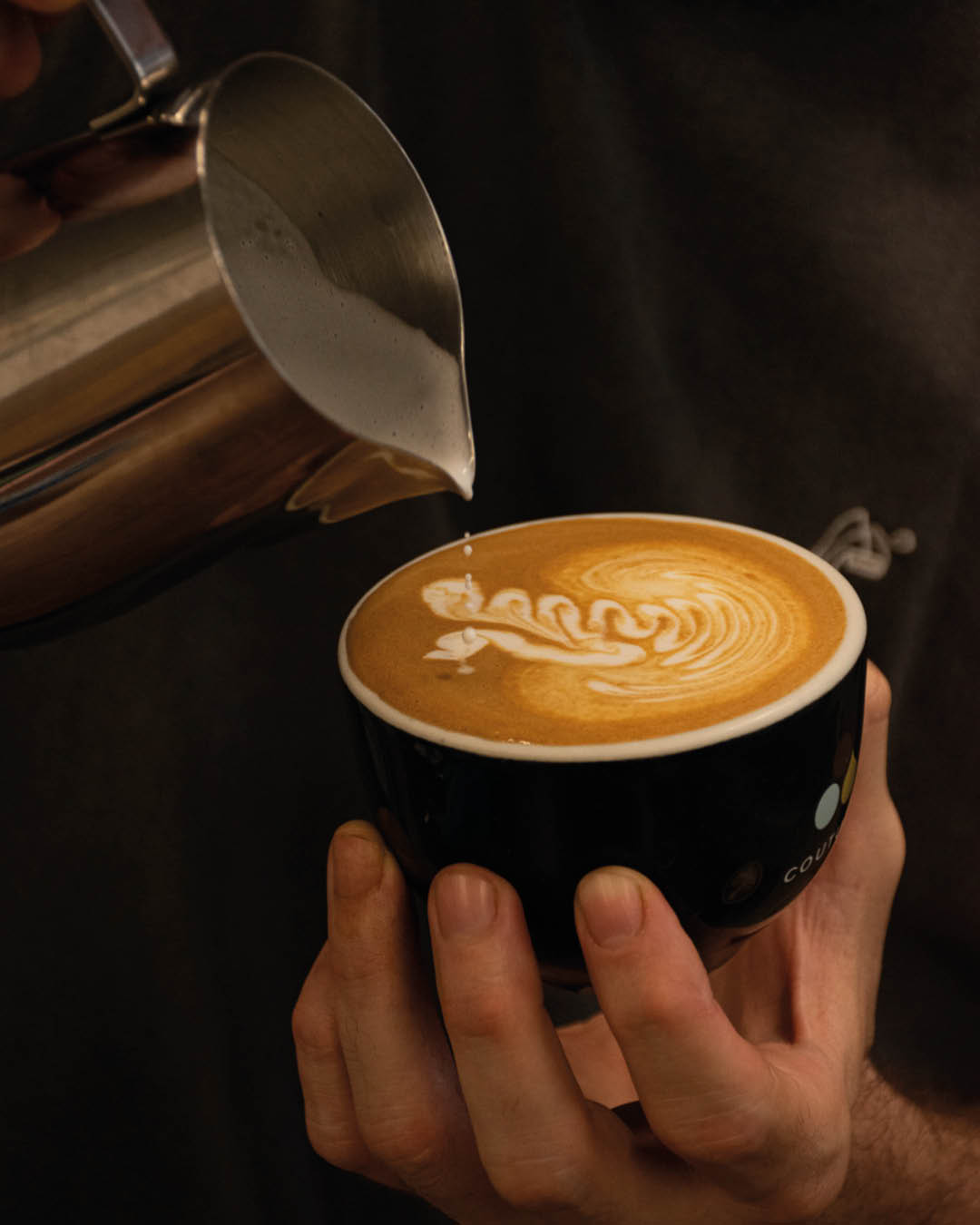 Latte art being prepared at Coutume coffee shop in Paris.