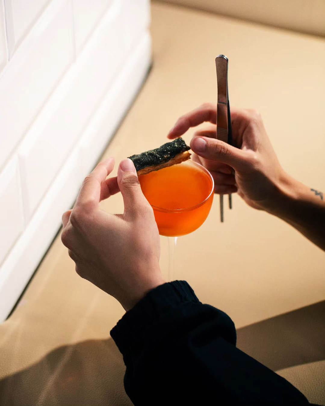 A red cocktail being prepared at Nutmeg & Clove cocktail bar in Singapore.