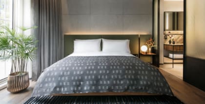 the warehouse hotel bed with throw