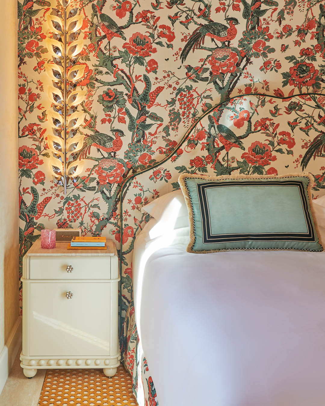 A patterned wallpaper blends into the headboard at Casa Monti in Rome