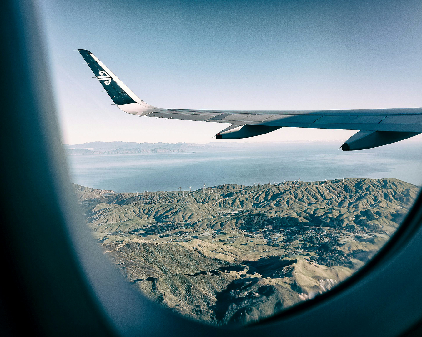 View from airplane window over New Zealand landscapes