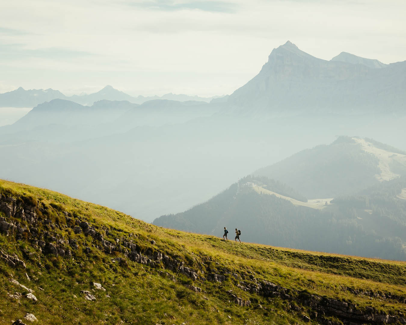 Hikers in the Alta Badia valley with mountains in backdrop