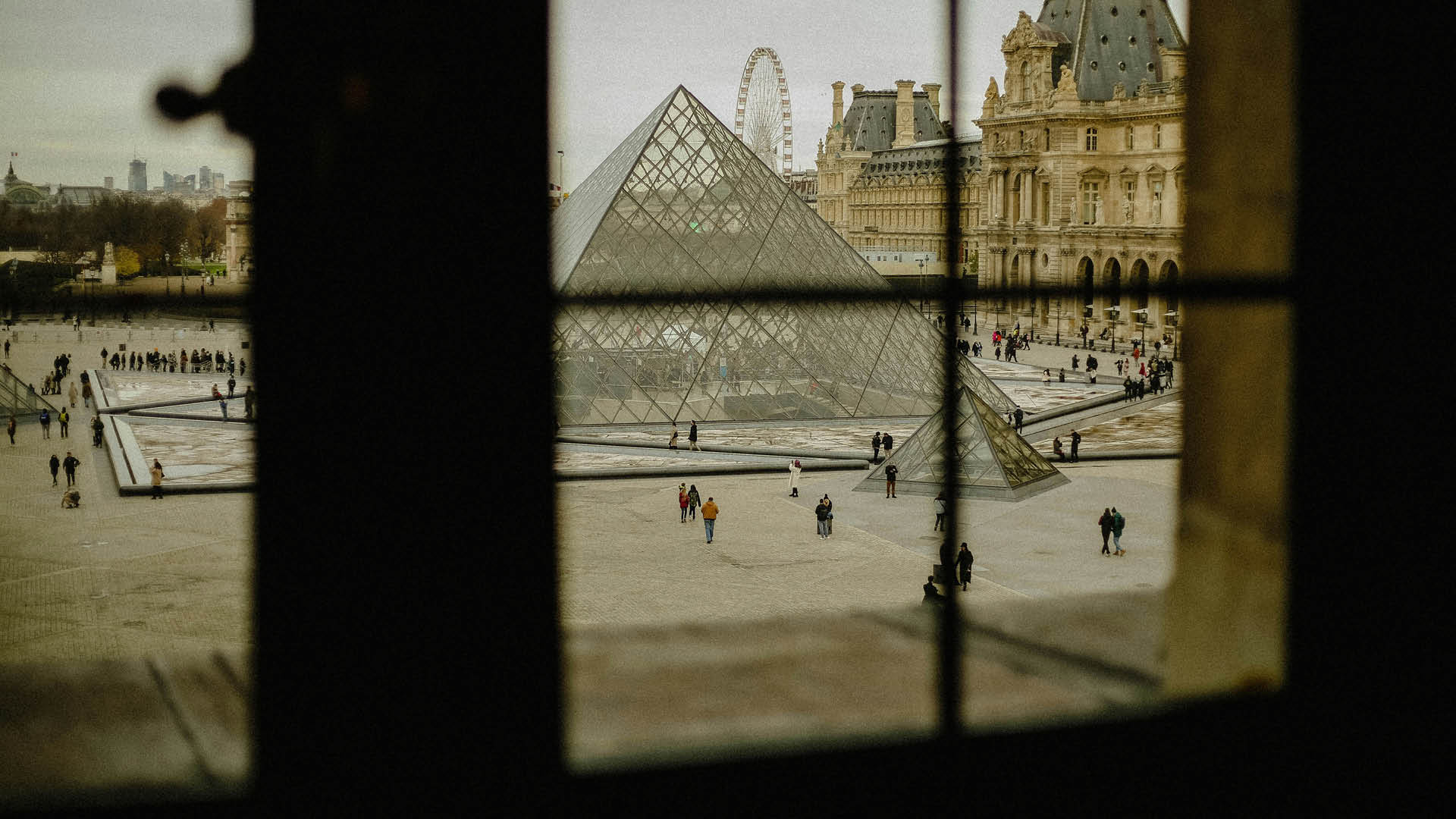 The courtyard of the Louvre, partially obscured by a windowpane.