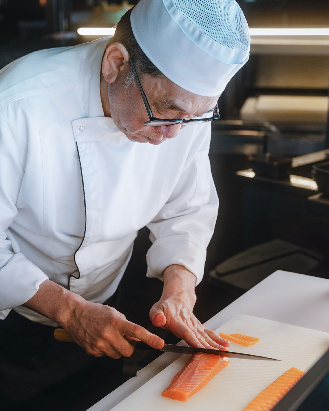 Chef Chitoshi Takahashi prepares a dish at Tomo